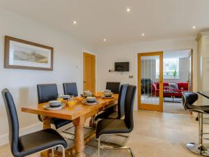 a dining room with a wooden table and black chairs at Church Manor in Carlton