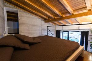 a bedroom with a large bed with a wooden ceiling at Pietranera Apartments in Catania