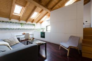a living room with a couch and a table at Pietranera Apartments in Catania