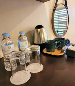 two bottles of water and cups on a wooden table at Cebu Quincentennial Hotel in Cebu City