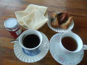 a table with two cups of coffee and toast at Taman Sari Tagtag in Sanur