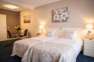 Postel nebo postele na pokoji v ubytování First Euroflat Hotel