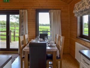 a dining room with a table with chairs and a window at Dartmoor - Uk12537 in Witheridge