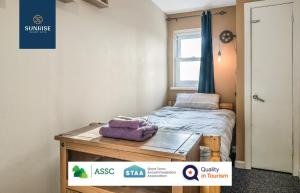 a small room with a bed and a window at THE LAW, 4 Rooms with TVs, 2 Bathrooms, Central, Free Parking, Fully Equipped, Long Stay Rates Available visit SUNRISE SHORT LETS in Dundee