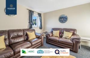 a living room with two brown leather couches at THE LAW, Guest FAVOURITE, 4 Rooms with TVs, Central, Free Parking, Fully Equipped, 2 Bathrooms, Long Stay Rates Available by SUNRISE SHORT LETS in Dundee