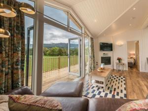 a living room with a couch and a large window at Karelia Lodge in Kenmore