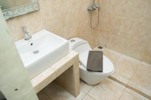 a bathroom with a white toilet and a sink at DS Colive 34 in Semarang