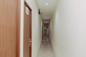 a corridor of a hallway with a door and a room at DS Colive 34 in Semarang