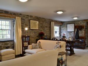 a living room with a couch and a table at The Mill in Tregaron