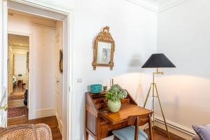 a living room with a table and a lamp at GuestReady - Stylish Apt near Luxembourg Gardens in Paris