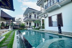 a swimming pool in front of a house at Queen Bisma Villa - 10 min walking to Ubud Center in Ubud