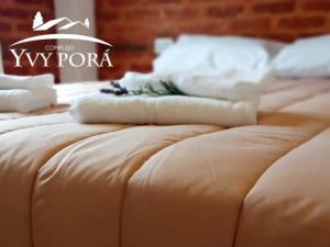 a close up of two beds with white pillows on them at Complejo Yvy Porá in Goya