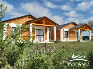 a house with a lawn in front of it at Complejo Yvy Porá in Goya +3 photos