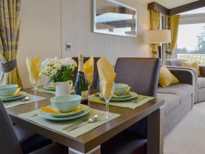 a dining room table with plates and wine glasses at Skylark Lodge in Westward