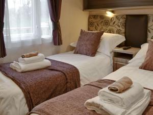 a hotel room with two beds with towels on them at Skylark Lodge in Westward