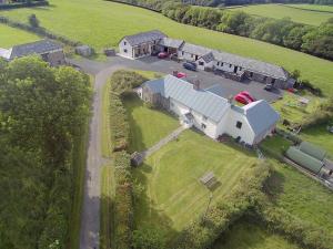 an aerial view of a large white house with a barn at Cider Cottage - Uk11861 in North Tamerton