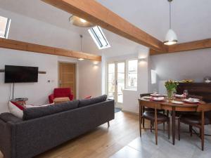 a living room with a couch and a table at The Old Surgery in Charlton