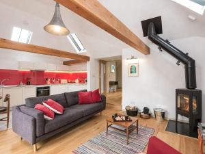 a living room with a couch and a fireplace at The Old Surgery in Charlton