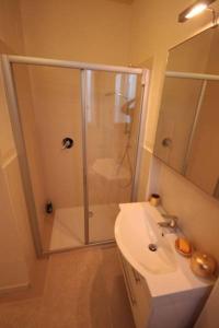 
a bathroom with a shower, sink, and mirror at Sottoriva36 in Verona
