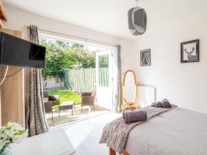 a bedroom with a bed and a sliding glass door at The White House in Montrose