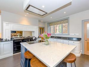 a kitchen with a large island with a vase of flowers at Eden Grove in Crosby