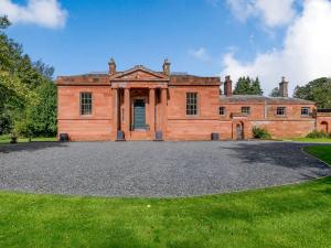 an old brick house with a large driveway at Eden Grove in Crosby