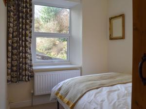 a bedroom with a bed and a window at North View in Bradwell