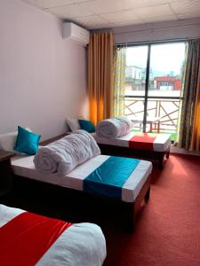 Habitación con 3 camas y ventana en Hotel Good One, en Pokhara