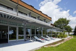 einen externen Blick auf ein Gebäude mit Liegestühlen in der Unterkunft NaturKulturHotel Stumpf in Neunkirchen