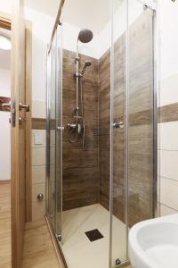 a shower with a glass door and a sink at Cambrembo a 3km da foppolo casa x6persone con Camino e Wifi in Valleve