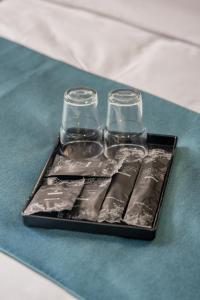 a tray with two glasses on a table at Hotel 28 Chow Kit Kuala Lumpur in Kuala Lumpur
