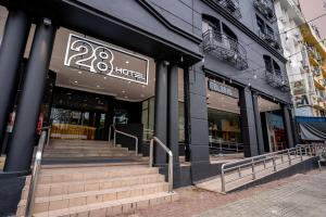 a store front with stairs in front of a building at Hotel 28 Chow Kit Kuala Lumpur in Kuala Lumpur
