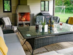 a patio with a table and a fireplace at Hayscastle Farmhouse in Hayscastle
