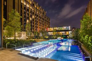 a large swimming pool with blue water at night at M Resort & Hotel Kuala Lumpur in Kuala Lumpur