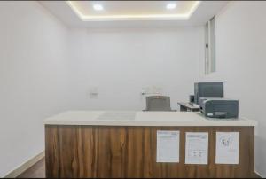 a counter in a room with acomputerasteryasteryasteryasteryasteryasteryasteryastery at Hotel Sayee luxury Inn in Pune