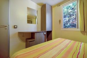 a bedroom with a bed and a sink and a window at Camping Grande Italia Maddalena 6 in Chioggia