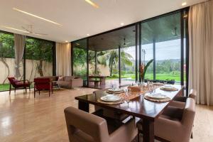 a large dining room with a table and chairs at StayVista Bella Antlia 3BHK, with Pvt Pool & Paddy view- Parra, North Goa in Anjuna