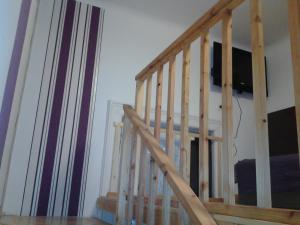 a wooden staircase with a television in a room at Liechtenstein Apartments in Budapest