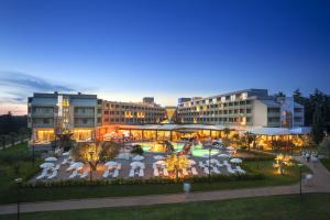 an aerial view of a hotel with tables and umbrellas at Aminess Vival Maestral Hotel in Novigrad Istria