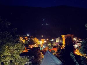 a view of a city at night with lights at Guesthouse Data in Mestia