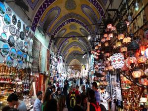 a crowd of people walking through a market with lights at Hotel Linda in Istanbul