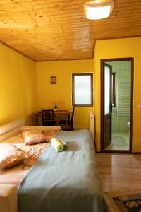 a bedroom with a bed and a table and a mirror at Pensiunea Novac in Durau