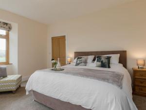 a bedroom with a large white bed and a window at The Farmhouse - Uk10655 in West Pennard