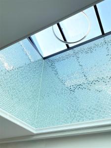 a skylight in a room with a glass ceiling at W Premium Guesthouse Incheon airport in Incheon