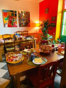 a dining room with a table with food on it at Aux couleurs de Commarin in Commarin