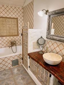 a bathroom with a sink and a tub and a mirror at Bungalov Trapani in Růžová