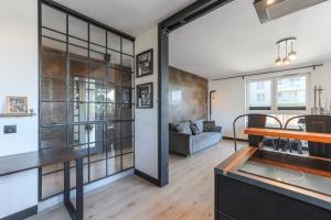 a kitchen and living room with a table and a couch at Apartament z Ogródkiem Gdańsk Stare Miasto in Gdańsk