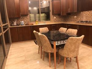 a kitchen with a table with chairs and a counter at Old Jericho homestay in Jericho