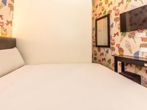 a bedroom with a bed and a desk and a mirror at Gold City Hotel in Malacca