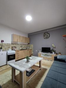 a kitchen with a table in the middle of a room at Stan na dan Goran Pale in Pale